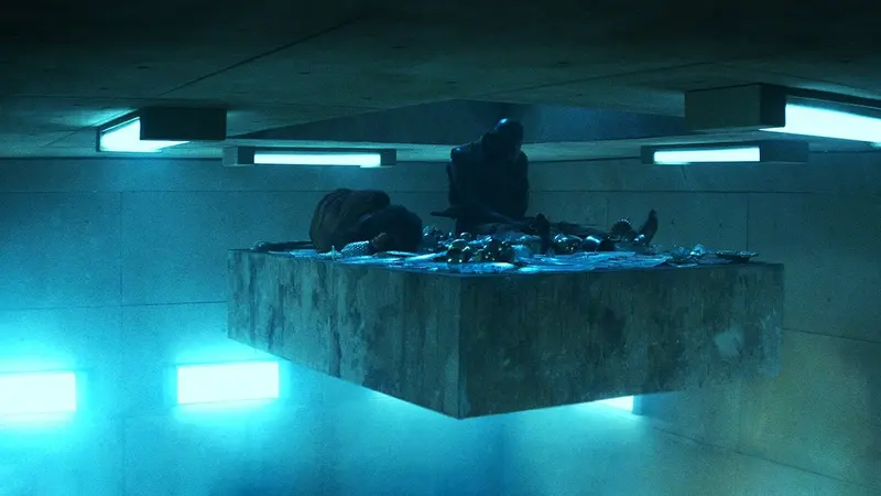The food platform descending through the concrete shaft of the vertical prison in The Platform