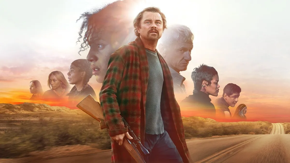 Leonardo DiCaprio walking down a desert road with the cast behind him in One Battle After Another key art