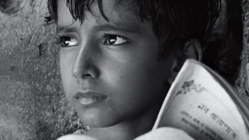 A close-up of the boy Apu in black and white in Satyajit Ray's Pather Panchali